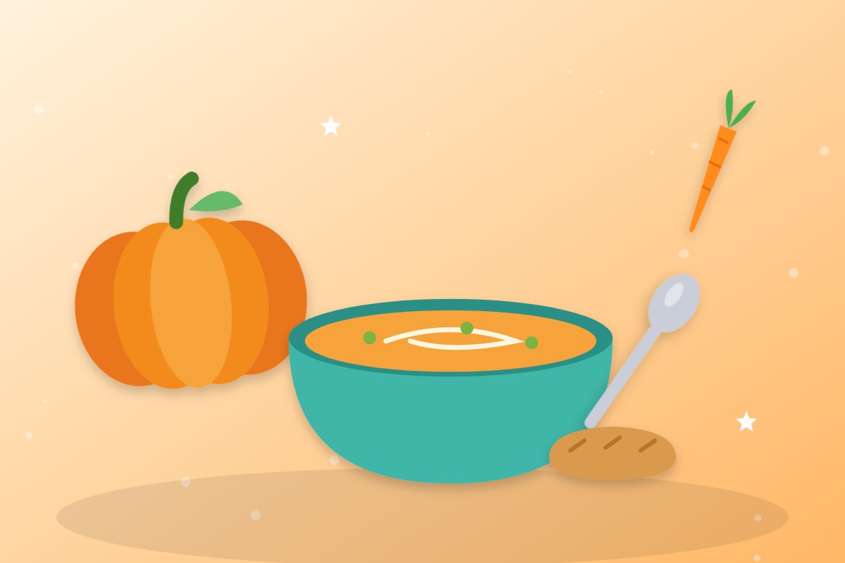 Cuenco turquesa con crema de calabaza junto a una calabaza y una zanahoria