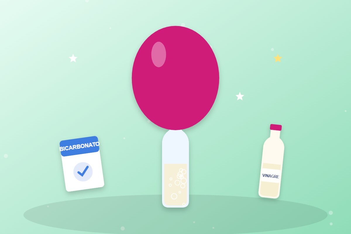 Botella con vinagre y un globo rosa inflado encima, junto a una caja de bicarbonato
